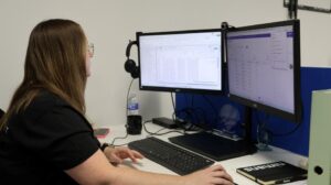 Qlic Employee at her desk