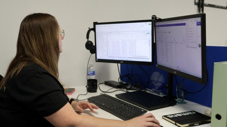 Qlic Employee at her desk